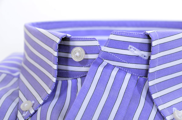 Close-up of a shirt button and reinforced buttonhole