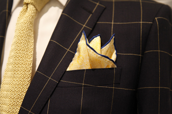 Coordinating a tie and pocket square without matching exactly Yellow tie paired with a coordinating pocket square